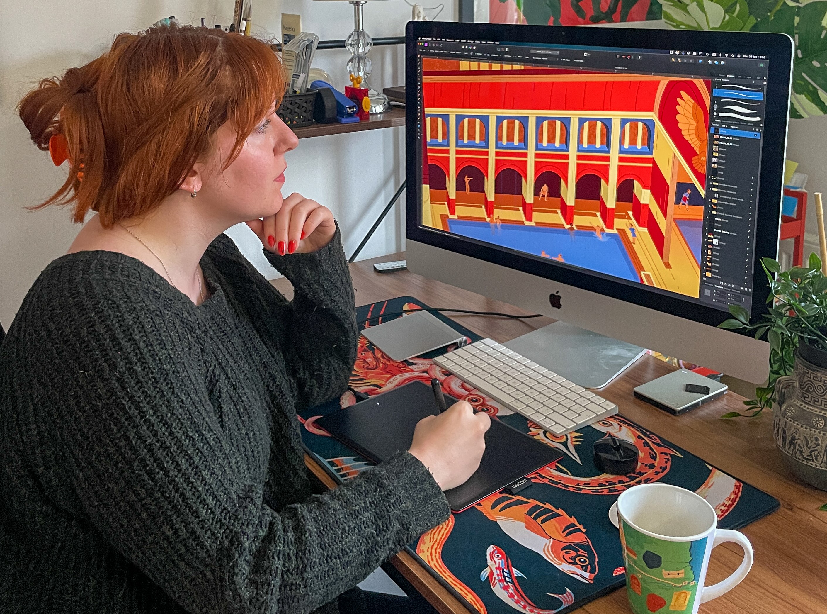 Artist Flora Kirk draws an image of the Roman Baths on her computer