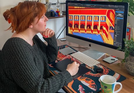 Artist Flora Kirk draws an image of the Roman Baths on her computer