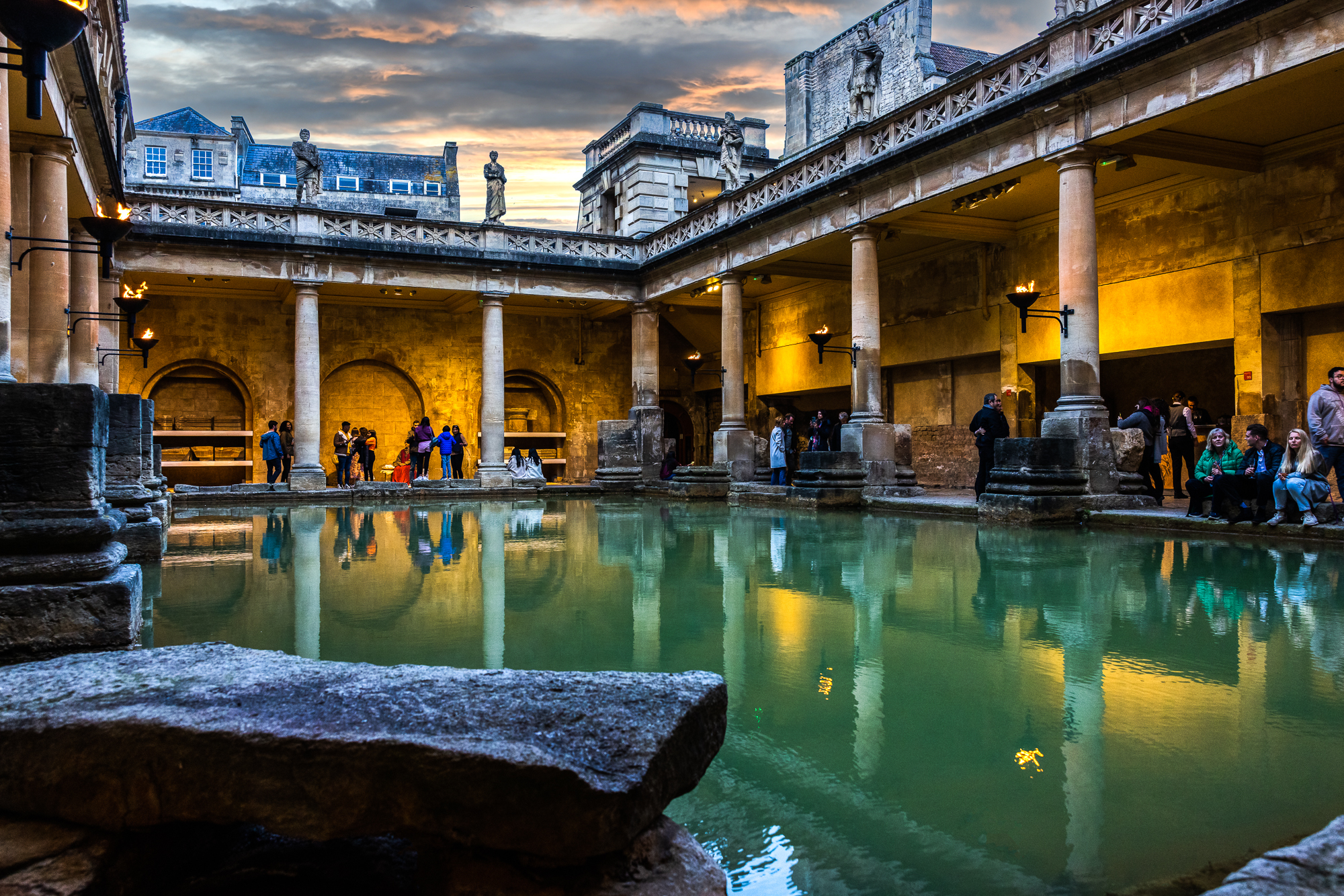 The Great Bath illuminated by torchlight in the summer