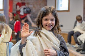 A schoolchild wearing a toga