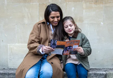 mother and daughter looking at leaflet