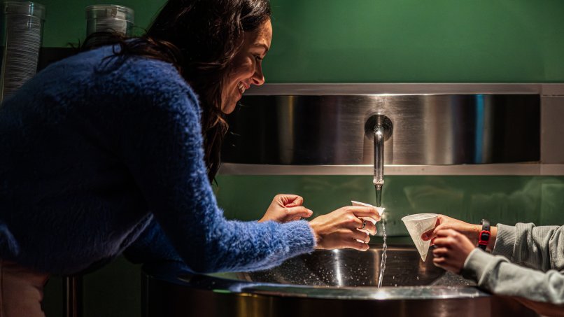 Woman tasting the spring water